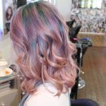 Curly Peach Hair Colouring with Green Highlights