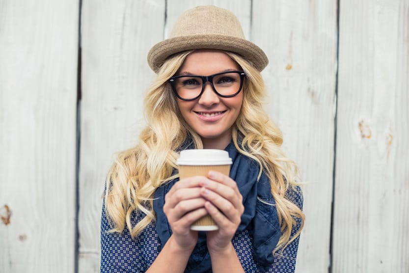 Woman With Healthy Blonde Hair Holding A Coffee