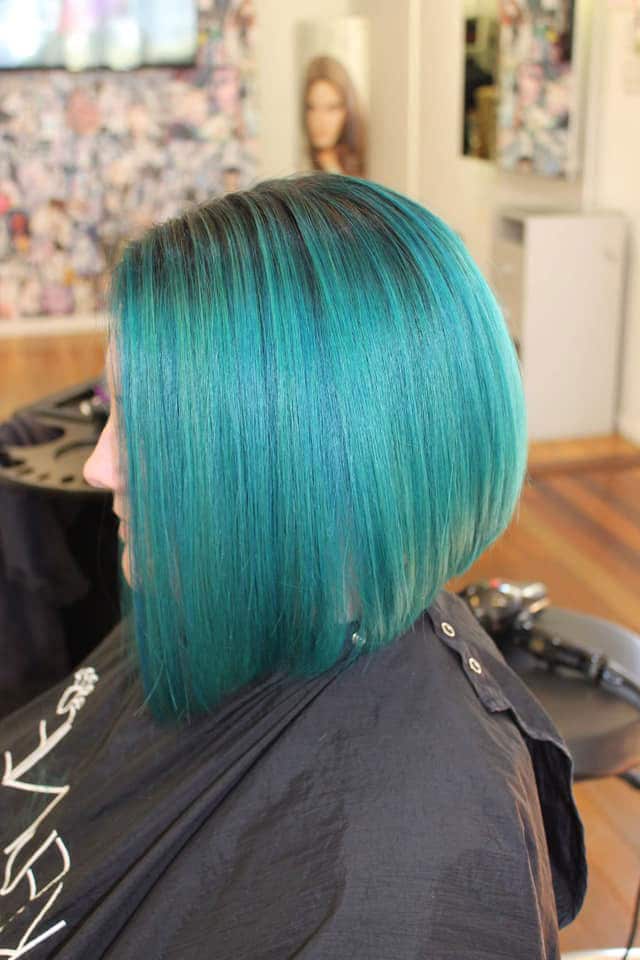 Woman With Green And Blunt Hair Cut