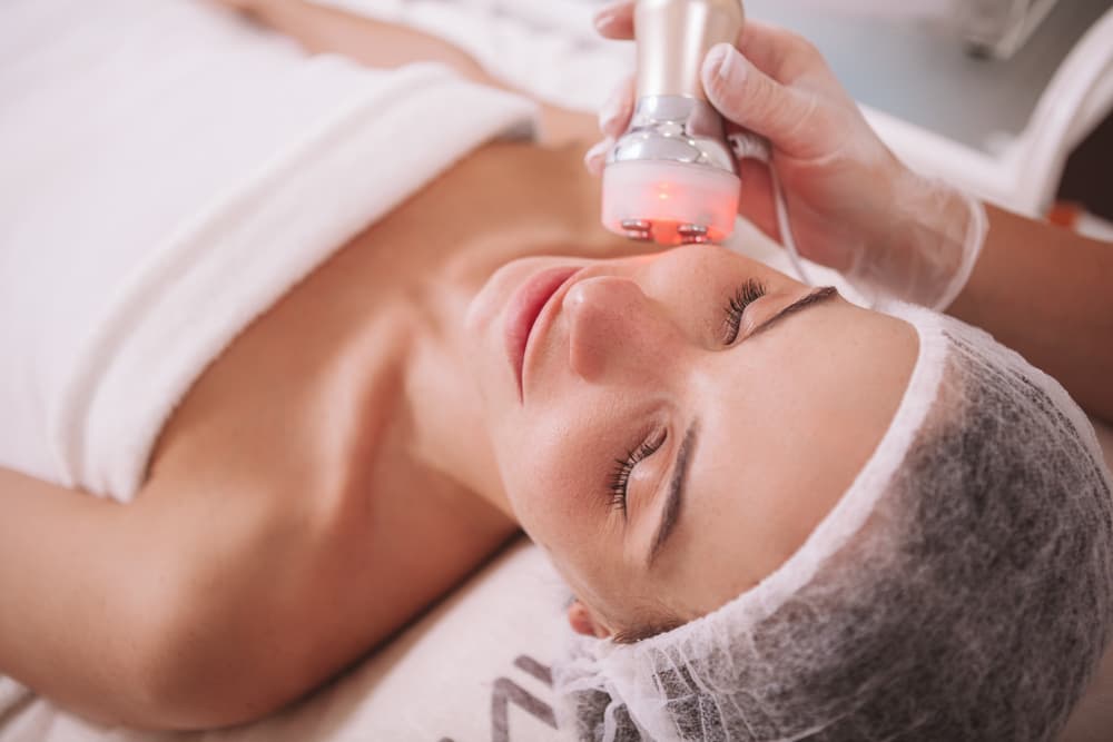 Beautiful Relaxed Woman Enjoying Rf-Lifting Session At Beauty Salon. Professional Cosmetologist Doing Skin Tightening Procedure For Female Client — Strut Hair & Beauty in Maroochydore, QLD